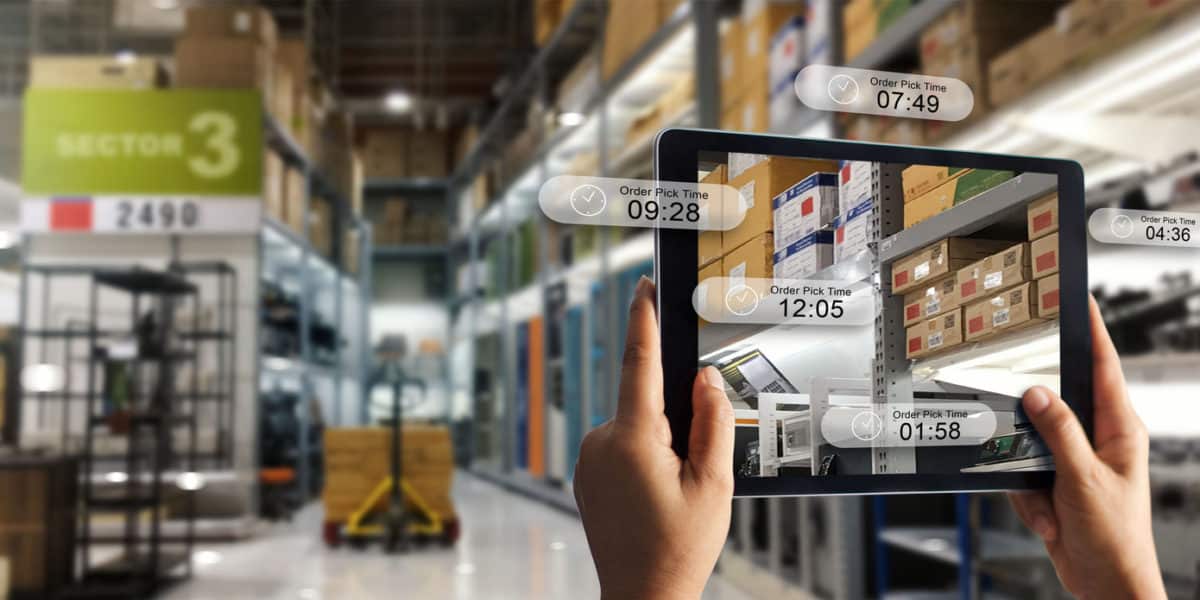 Augmented reality online shopping concept. E-commerce and digital marketing. Hand holding digital tablet smart phone use AR application to check order pick time on storage factory background.